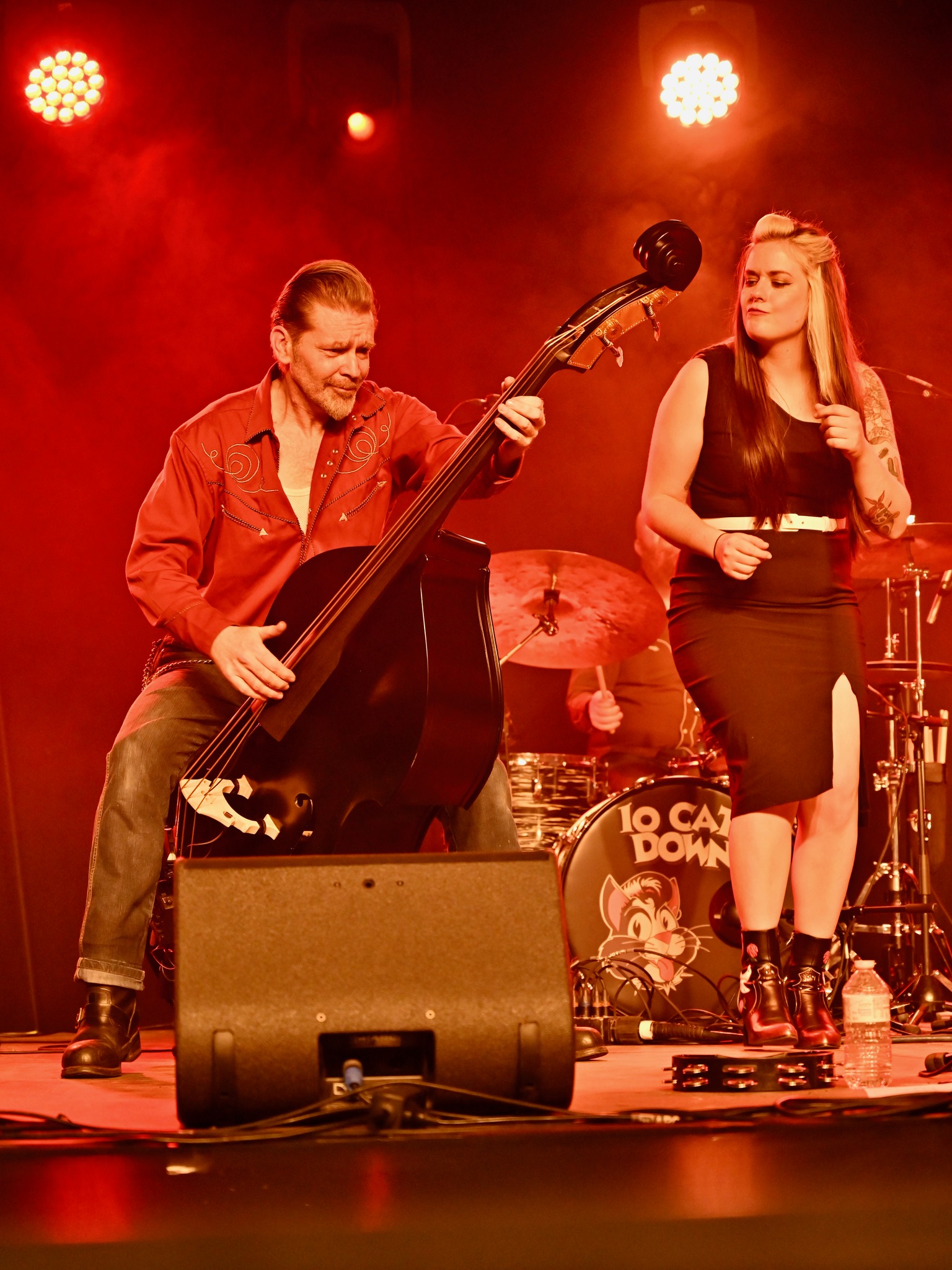 Band performing under dramatic red stage lighting