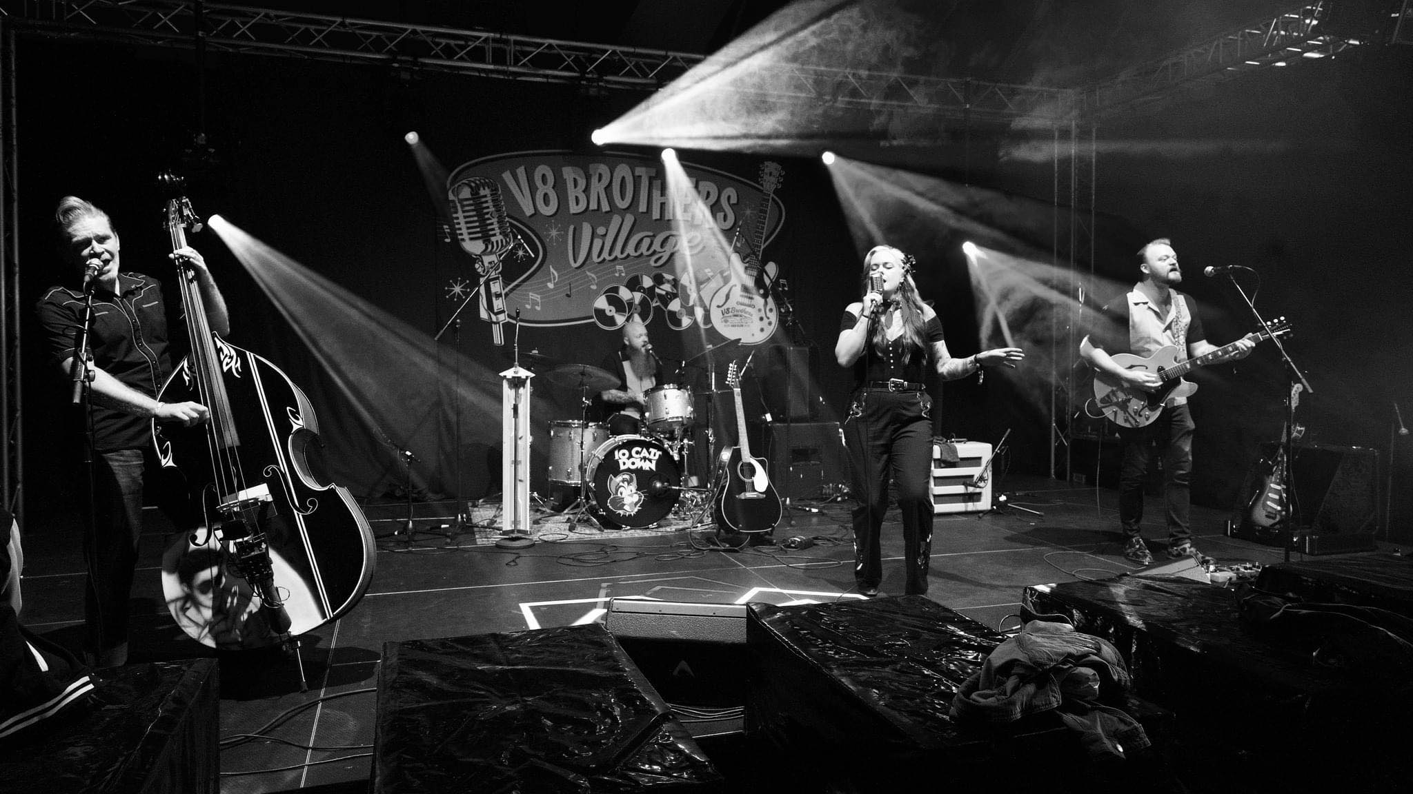 Full band black and white shot at V8 Brothers Village